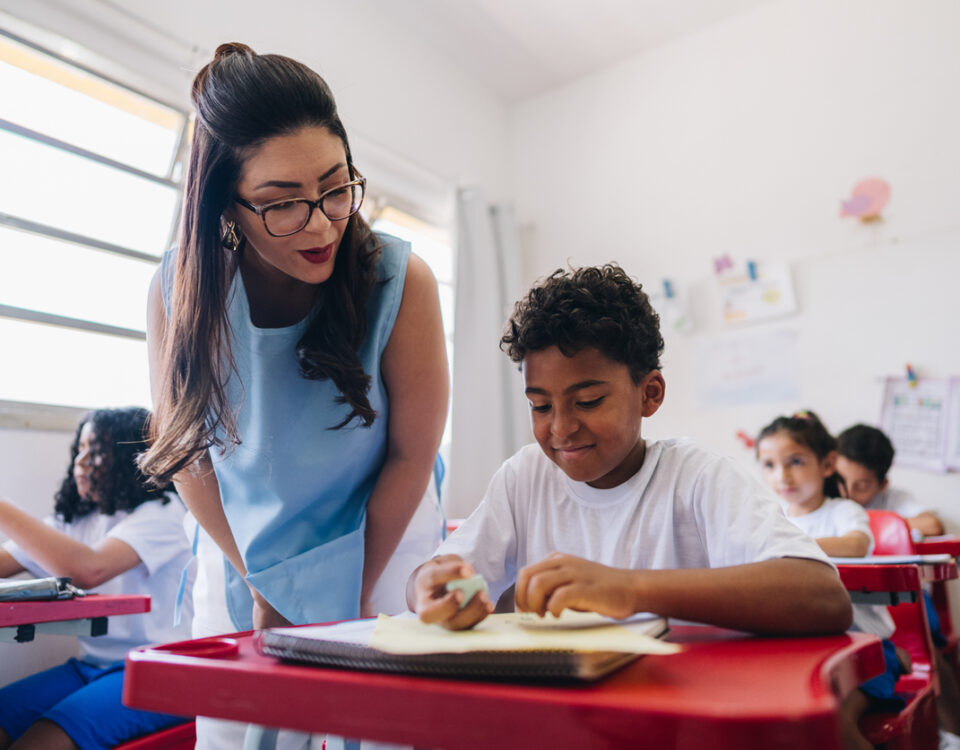 Educators legal liability insurance: Teacher teaching her student on classroom at school